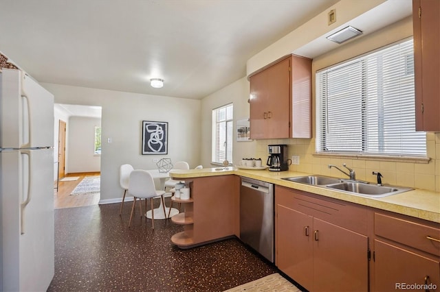 2431 S York St, Denver, CO 80210 - kitchen featuring freestanding refrigerator, dishwasher, decorative backsplash, a peninsula, and light countertops