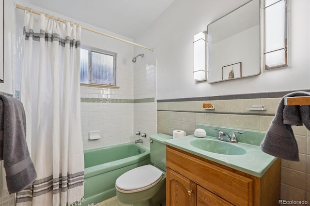 2431 S York St, Denver, CO 80210 - full bathroom featuring shower / tub combo, vanity, tile walls, and a wainscoted wall