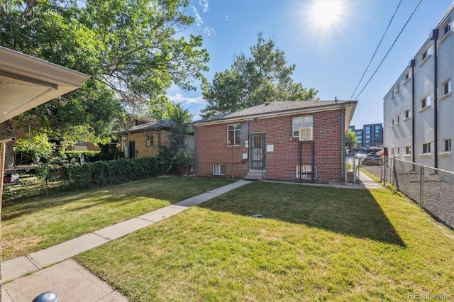 2431 S York St, Denver, CO 80210 - back of house featuring brick siding, a gate, and cooling unit