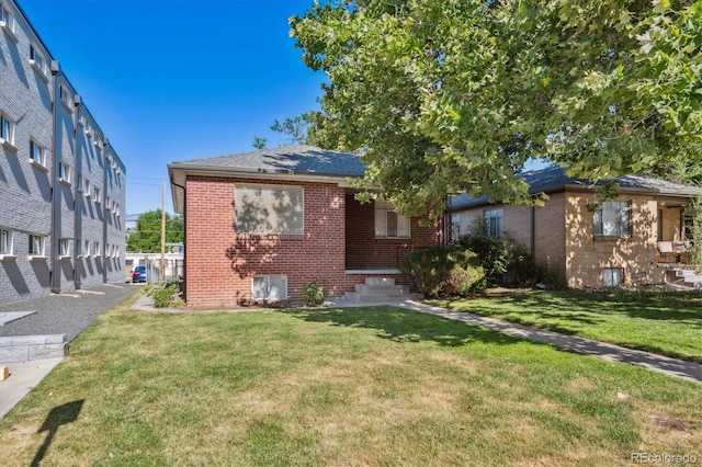 2431 S York St, Denver, CO 80210 - view of front of home with brick siding, a front yard, and roof with shingles