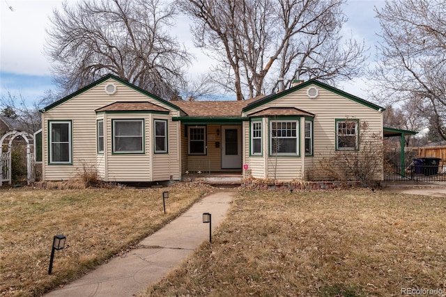 ranch-style house with a front lawn and fence