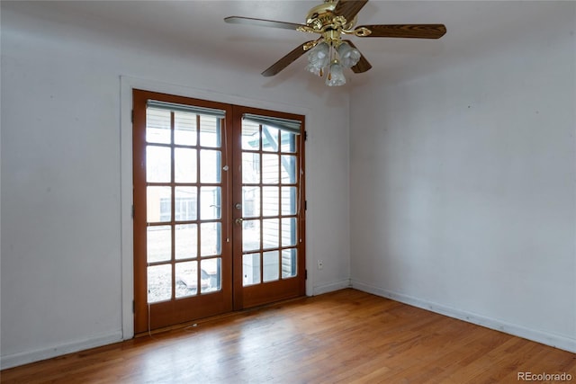 unfurnished room featuring french doors, baseboards, wood finished floors, and a ceiling fan