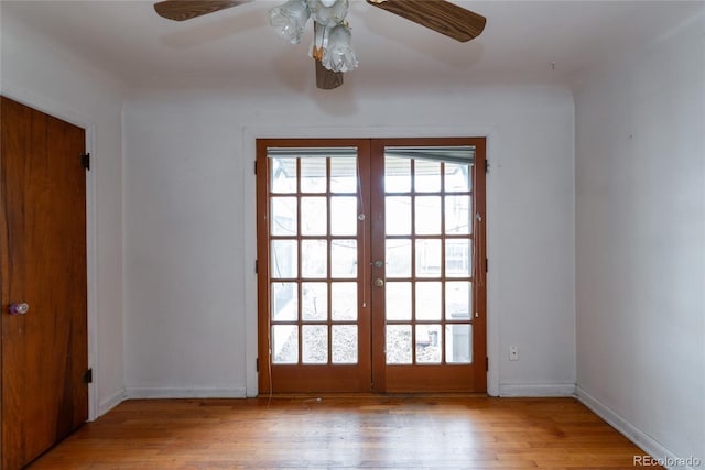 doorway with french doors, baseboards, light wood-style flooring, and a ceiling fan