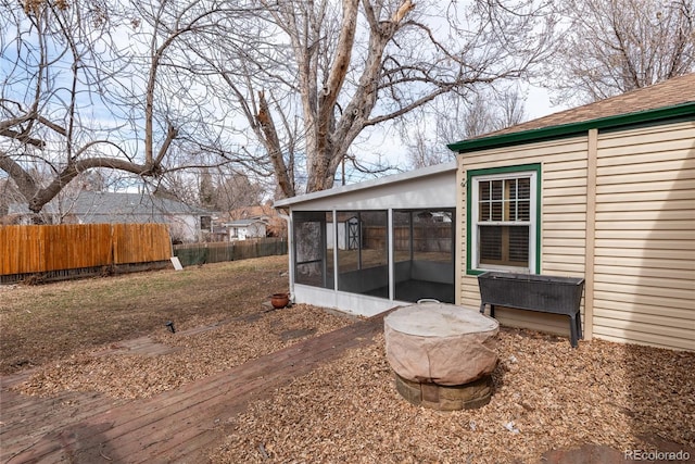 exterior space featuring fence and a sunroom