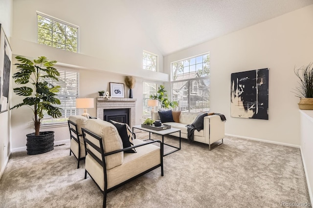 5016 S Nelson St Unit C, Littleton, CO 80127 - living area with carpet floors, a brick fireplace, high vaulted ceiling, baseboards, and a textured ceiling