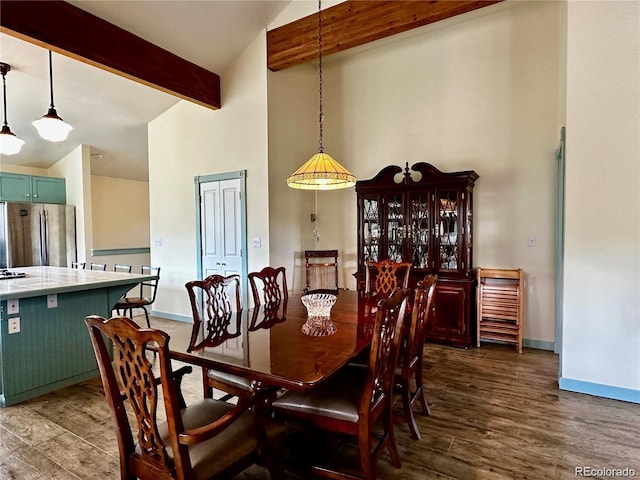 dining space with beamed ceiling, wood-type flooring, and high vaulted ceiling