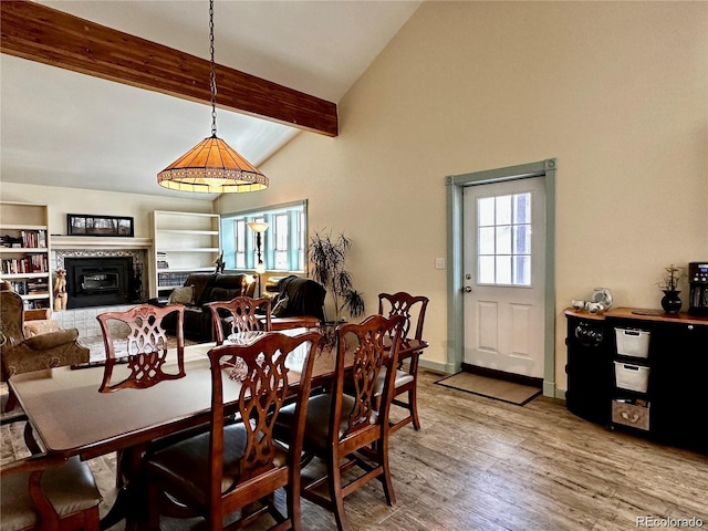 dining area featuring hardwood / wood-style floors and lofted ceiling with beams