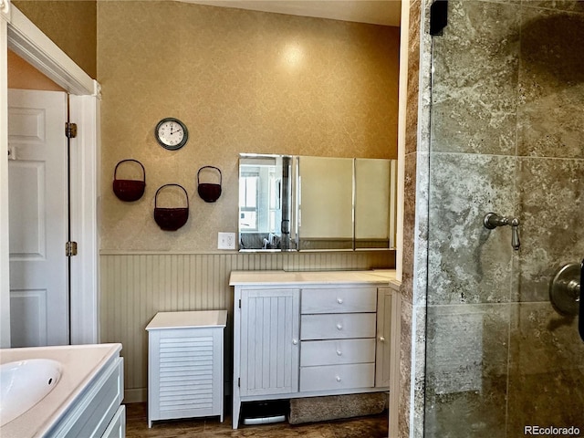 bathroom featuring a tile shower and vanity