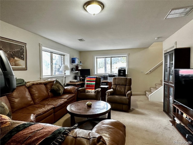 carpeted living room with plenty of natural light