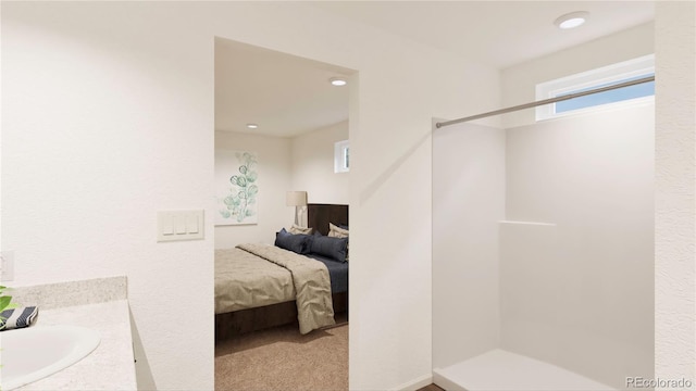 bathroom with walk in shower and vanity