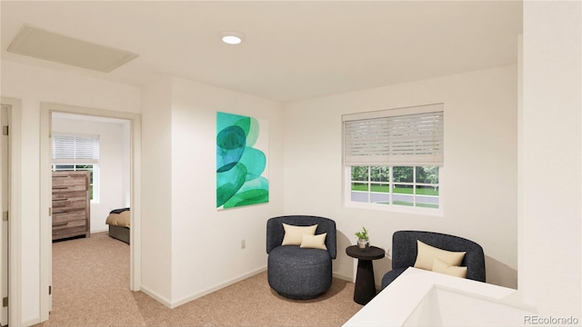 sitting room featuring light carpet and a healthy amount of sunlight