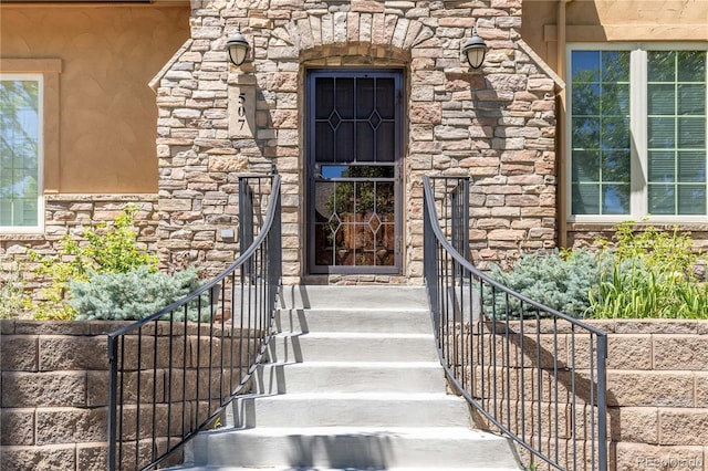 doorway to property featuring stone siding