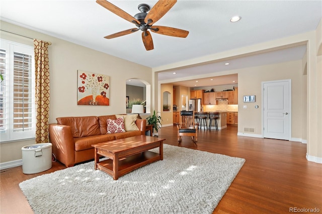 living area featuring dark wood-style floors, ceiling fan, baseboards, and recessed lighting