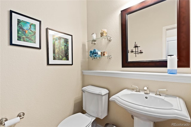 half bathroom with a sink and toilet