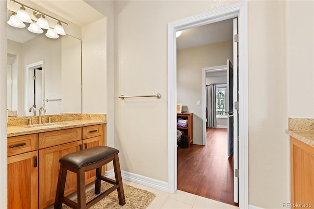 bathroom featuring vanity, baseboards, and tile patterned floors