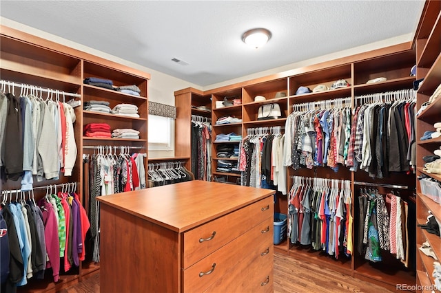 spacious closet featuring visible vents and wood finished floors