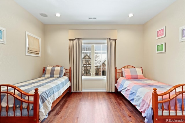 bedroom featuring baseboards, visible vents, wood finished floors, and recessed lighting