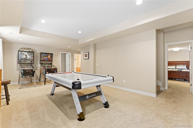 rec room featuring baseboards, a tray ceiling, light colored carpet, and recessed lighting