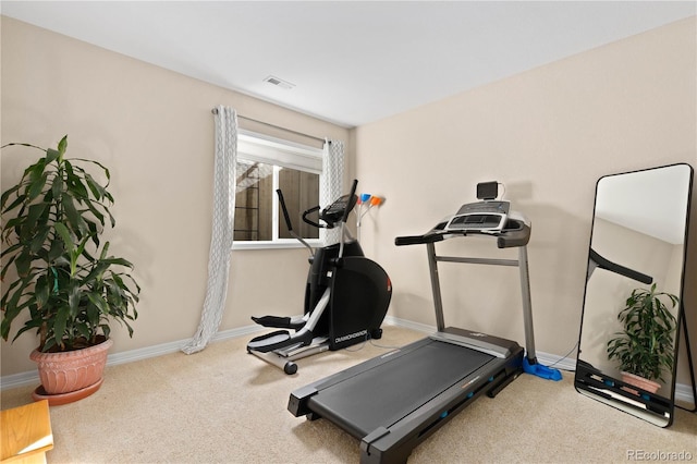 exercise room featuring carpet flooring, visible vents, and baseboards