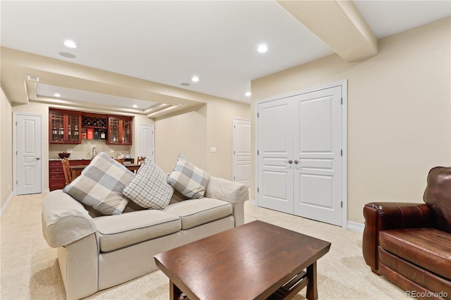 living room with baseboards, indoor wet bar, light colored carpet, and recessed lighting