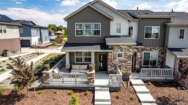 1500 Sun Way, Lafayette, CO 80026 - view of front facade featuring outdoor lounge area, board and batten siding, roof with shingles, a residential view, and covered porch