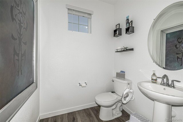 1500 Sun Way, Lafayette, CO 80026 - half bathroom featuring wood finished floors, toilet, and baseboards