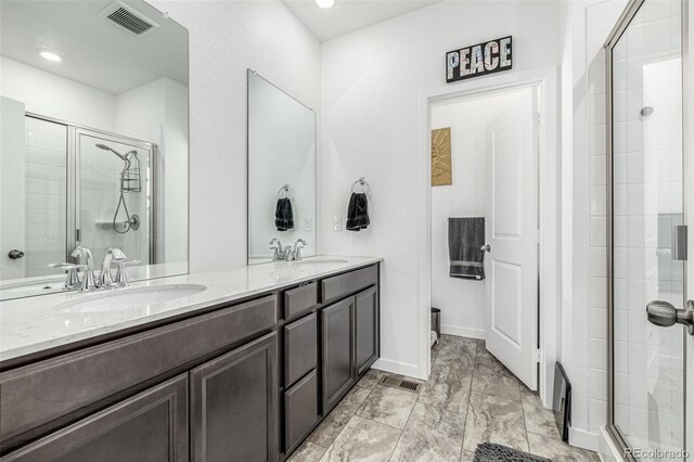 1500 Sun Way, Lafayette, CO 80026 - bathroom with a stall shower, double vanity, recessed lighting, and baseboards
