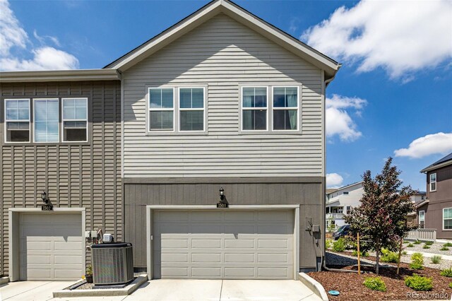 1500 Sun Way, Lafayette, CO 80026 - view of front of house featuring central AC unit, driveway, and a garage
