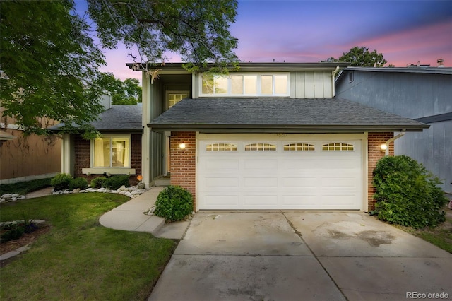 3889 S Fraser St, Aurora, CO 80014 - view of front of home with brick siding, concrete driveway, an attached garage, a lawn, and a shingled roof