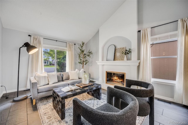 3889 S Fraser St, Aurora, CO 80014 - living area with a glass covered fireplace, high vaulted ceiling, and tile patterned floors