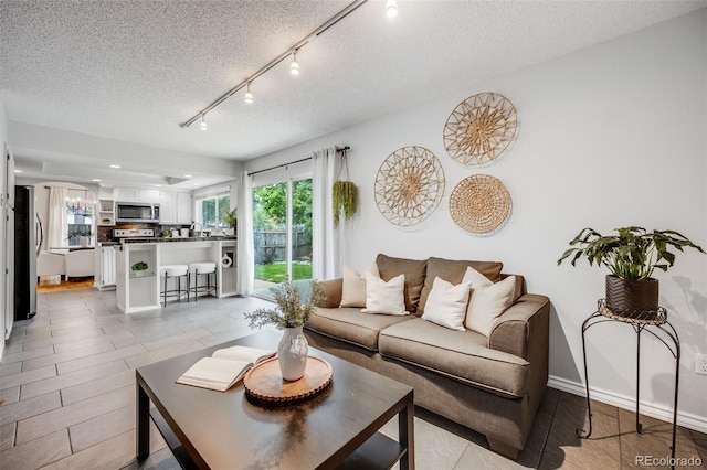 3889 S Fraser St, Aurora, CO 80014 - living area featuring a textured ceiling and track lighting