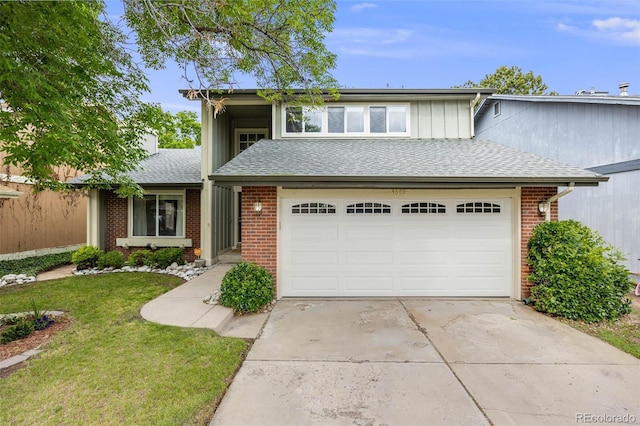 3889 S Fraser St, Aurora, CO 80014 - view of front facade featuring brick siding, driveway, an attached garage, roof with shingles, and a front yard