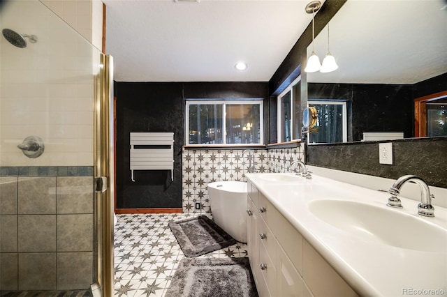 46 Apache Rd, Evergreen, CO 80439 - full bath with radiator heating unit, tile walls, a sink, and a stall shower