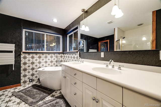 46 Apache Rd, Evergreen, CO 80439 - full bathroom featuring walk in shower, a sink, tile walls, a soaking tub, and double vanity