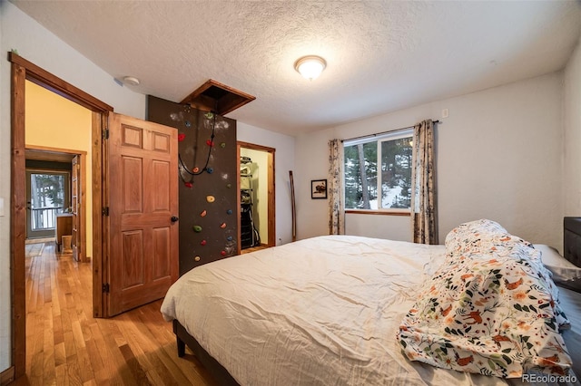 46 Apache Rd, Evergreen, CO 80439 - bedroom featuring light wood finished floors and a textured ceiling