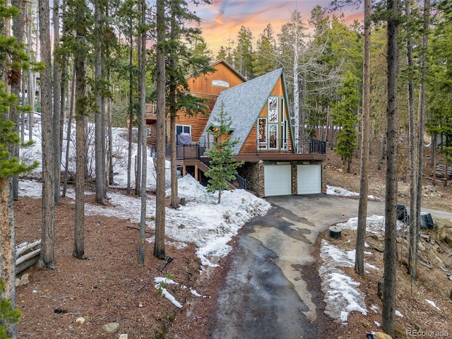 46 Apache Rd, Evergreen, CO 80439 - view of front of property featuring roof with shingles, stairs, an attached garage, driveway, and a deck