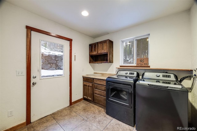 46 Apache Rd, Evergreen, CO 80439 - laundry area featuring washer and dryer, light tile patterned floors, baseboards, and cabinet space