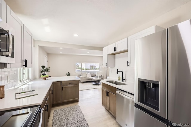 1750 S Zuni St, Denver, CO 80223 - kitchen with appliances with stainless steel finishes, backsplash, light countertops, recessed lighting, and open floor plan