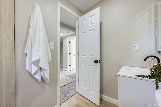 1750 S Zuni St, Denver, CO 80223 - bathroom with vanity and wood finished floors