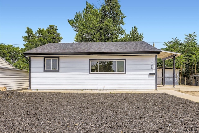 1750 S Zuni St, Denver, CO 80223 - view of home's exterior with an outdoor structure and a shingled roof