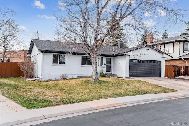 view of front of property with fence, concrete driveway, a front yard, a garage, and brick siding