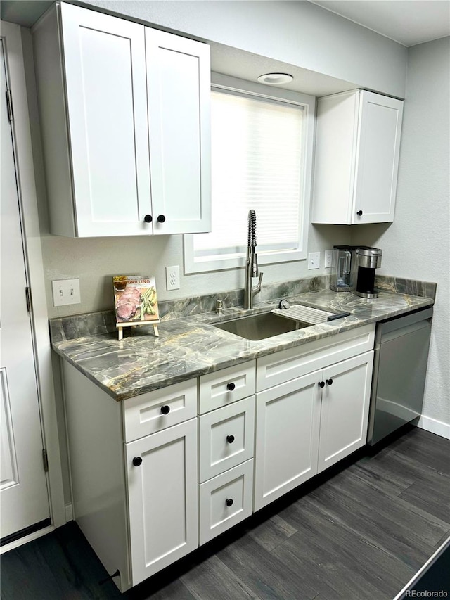 kitchen featuring dishwasher, sink, white cabinets, and dark hardwood / wood-style floors