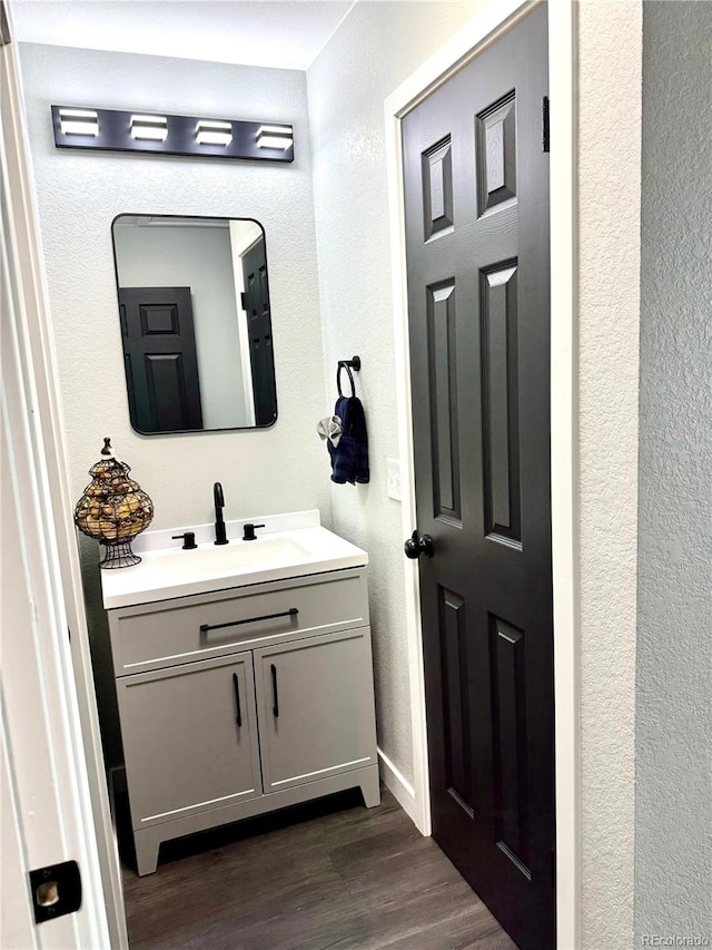 bathroom with hardwood / wood-style flooring and vanity