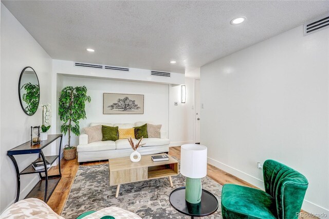 1250 N Humboldt St Unit 202, Denver, CO 80218 - living room featuring wood finished floors, a textured ceiling, and recessed lighting