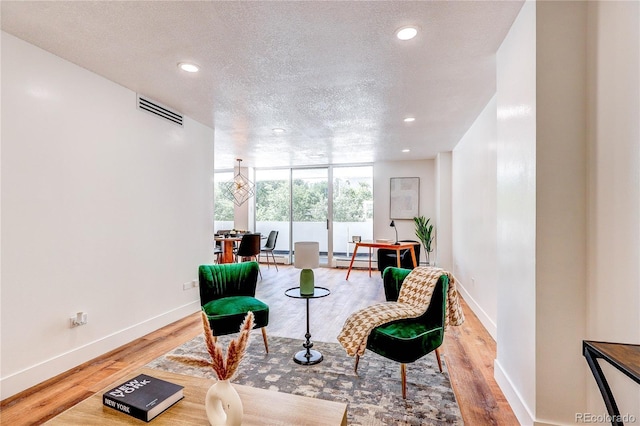1250 N Humboldt St Unit 202, Denver, CO 80218 - living area with recessed lighting, a textured ceiling, wood finished floors, and floor to ceiling windows