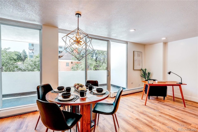 1250 N Humboldt St Unit 202, Denver, CO 80218 - dining area with a baseboard heating unit, a textured ceiling, a chandelier, expansive windows, and light wood-style floors