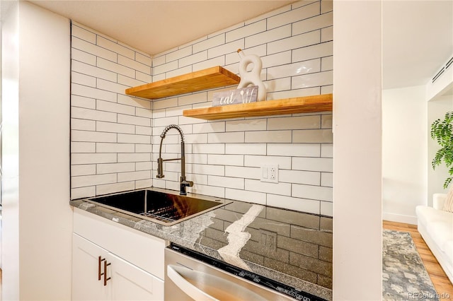 1250 N Humboldt St Unit 202, Denver, CO 80218 - kitchen featuring tasteful backsplash, stainless steel dishwasher, open shelves, and white cabinets