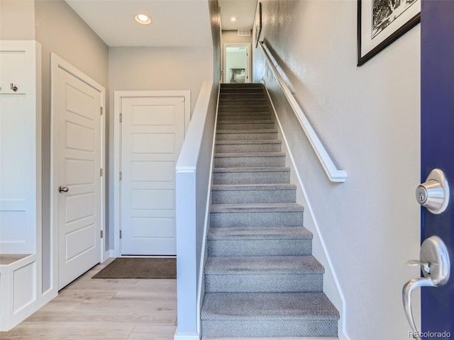 stairs with hardwood / wood-style flooring