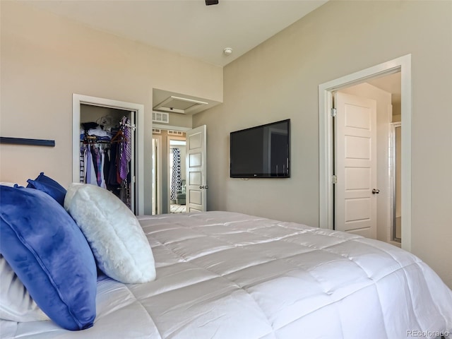 bedroom with a spacious closet and a closet