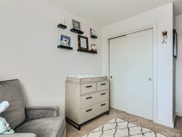 sitting room featuring light colored carpet